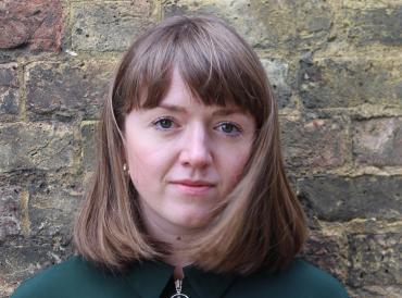 LAMDA graduate Emily Carewe and MishMash founder, looking directly at the camera against a backdrop of a brick wall