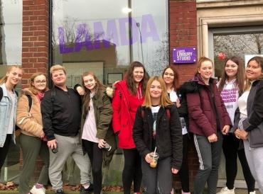 A group of young people standing outside LAMDA