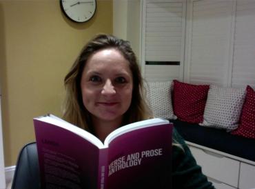 LAMDA teacher Jo O'Ferrall sitting at home with a LAMDA syllabi