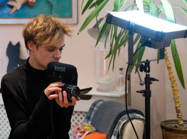 A LAMDA student holding a camera