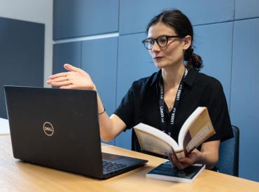 A short courses tutor in front of a laptop