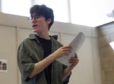 A student holding a script