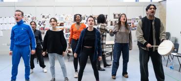 Eight members of the Image of an Unknown Young Woman cast during rehearsals