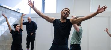 Four students rehearsing for the musical RENT
