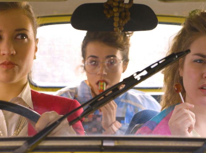 Three LAMDA students sitting in a car, taken from short film The Club