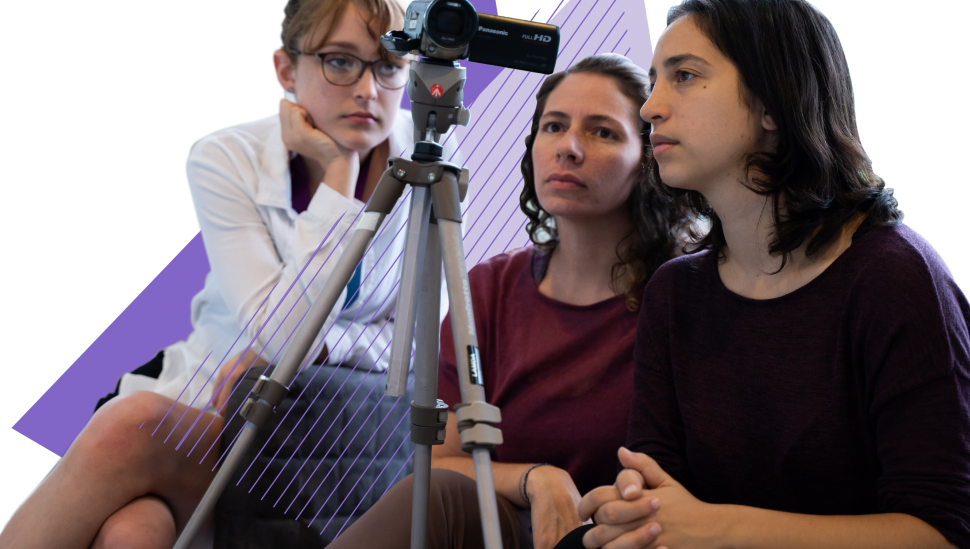 Three LAMDA Short course students looking at a camcorder