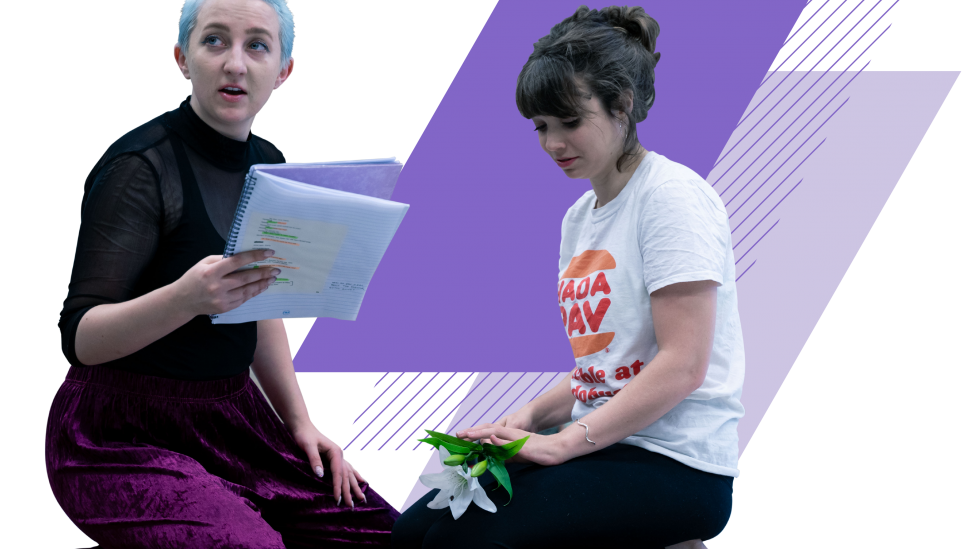 Two LAMDA short course students kneeling with scripts