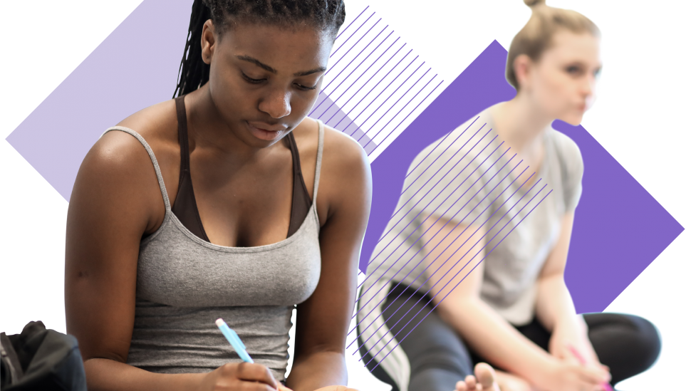 Two LAMDA short course students sitting next to each other, taking notes during a class and stretching