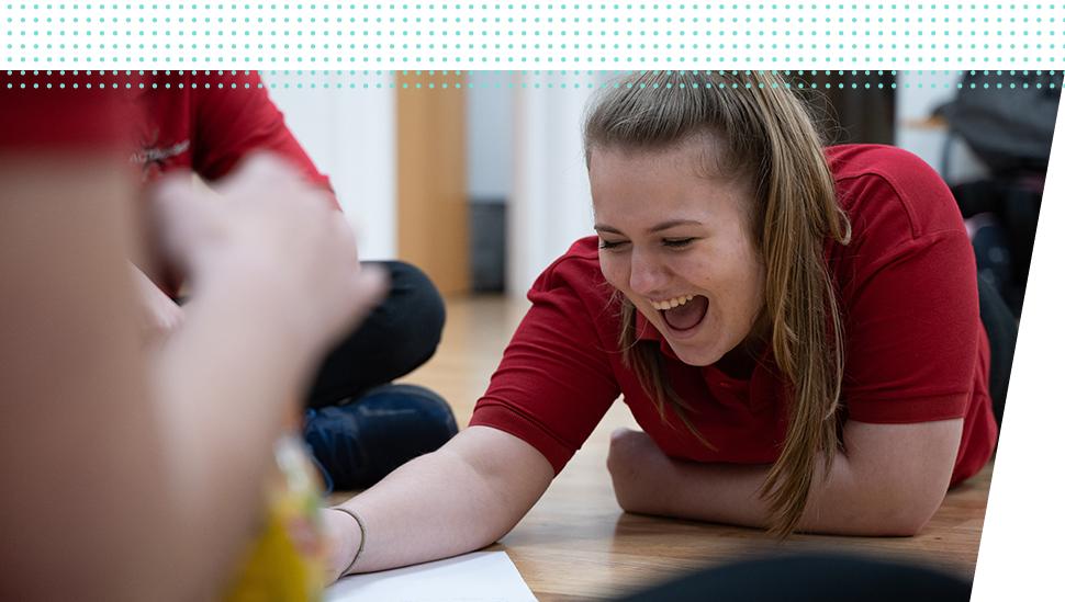 A LAMDA learner laughs working on a script