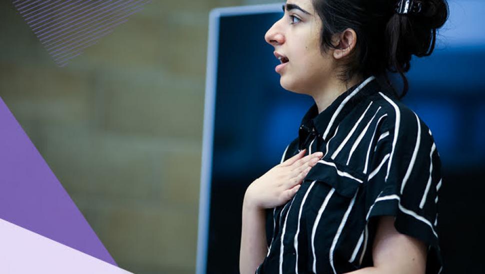 A young woman delivers a speech