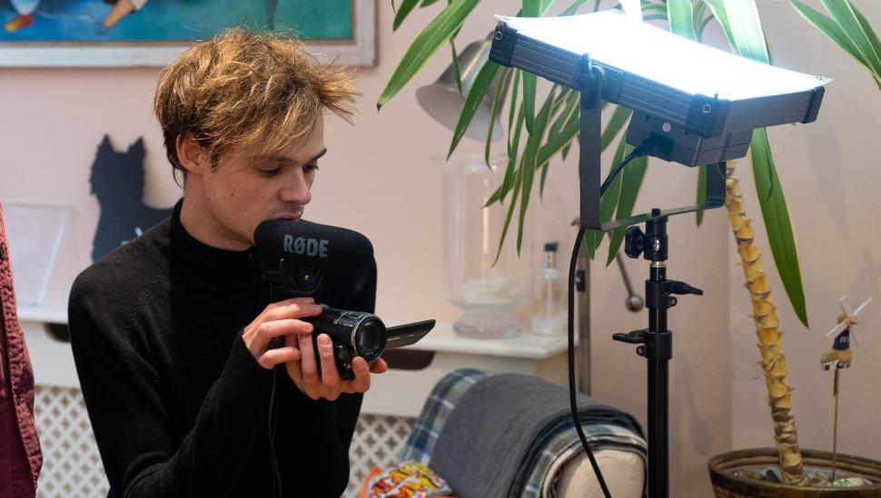 A LAMDA student holding a camera