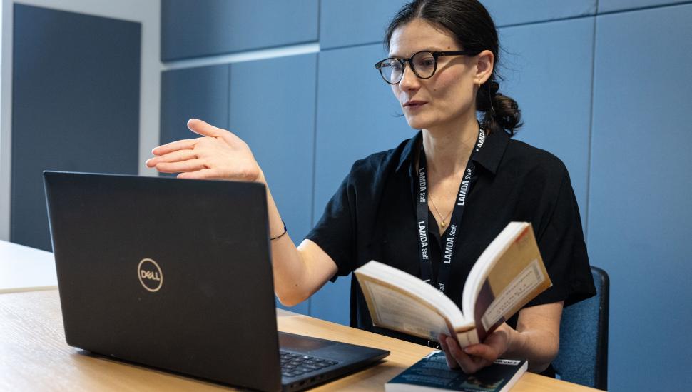 A short courses tutor in front of a laptop