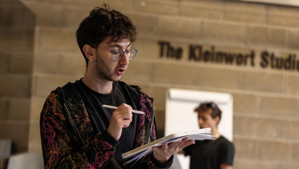 A student holding a notebook