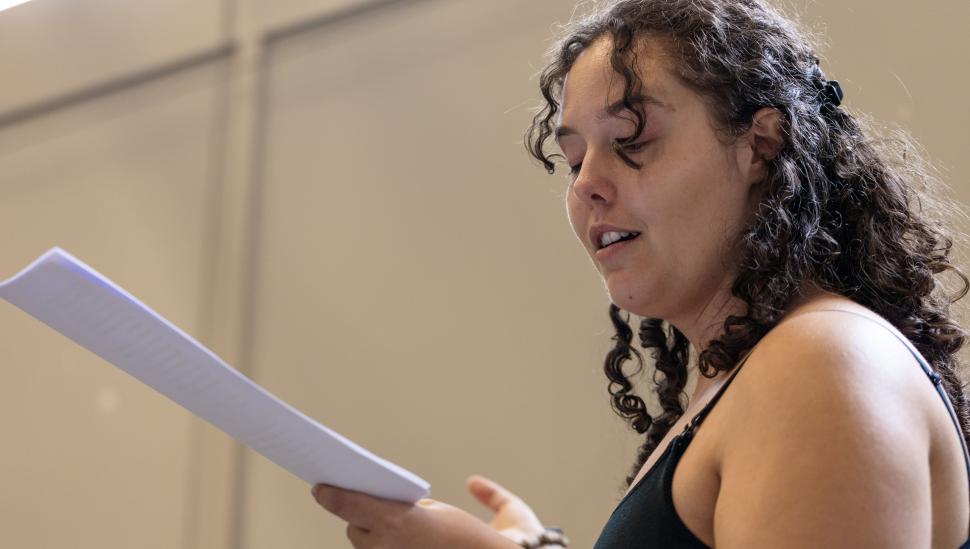 A participant in a short course holding a script