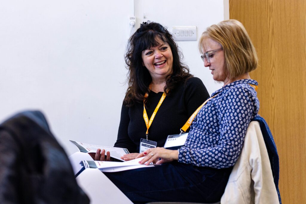 Two teachers talk during a course