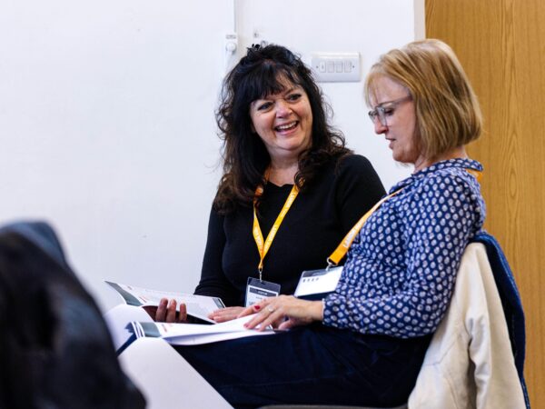 Two teachers talk during a course