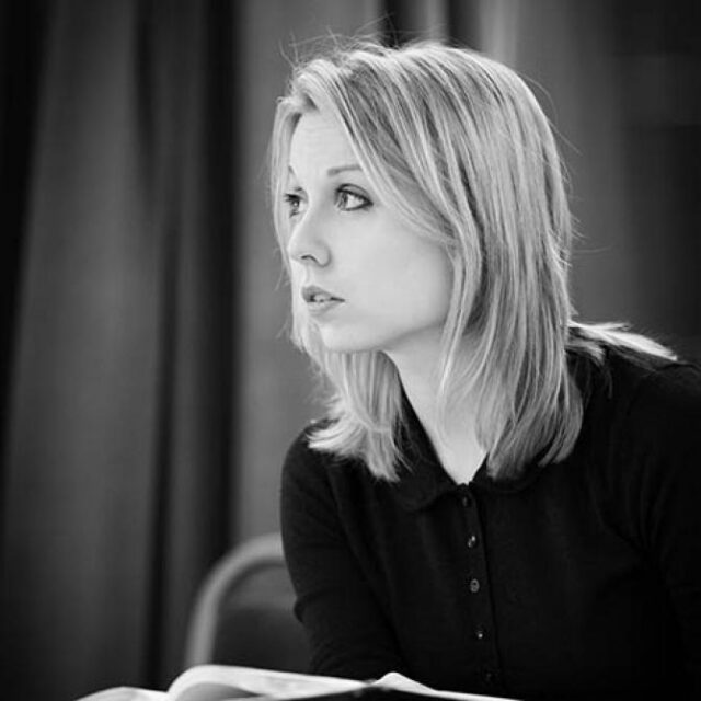 Black-and-white portrait of a woman with shoulder-length hair, looking thoughtfully to the side