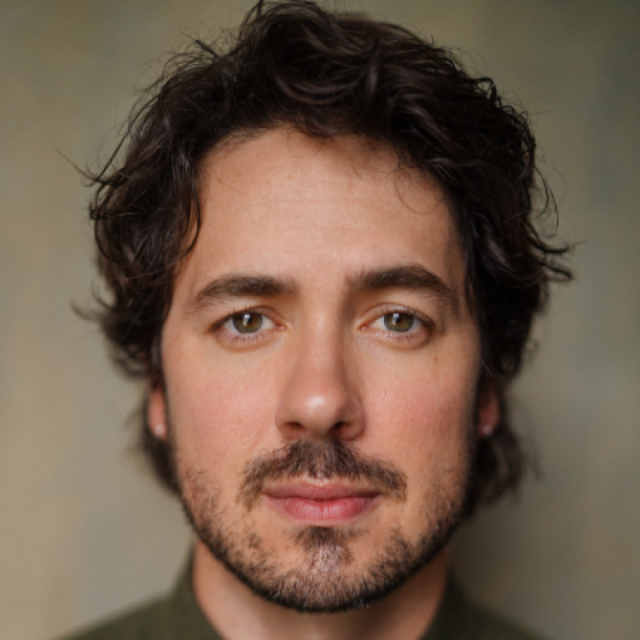 Portrait of a man with curly dark hair and a short beard, looking directly at the camera
