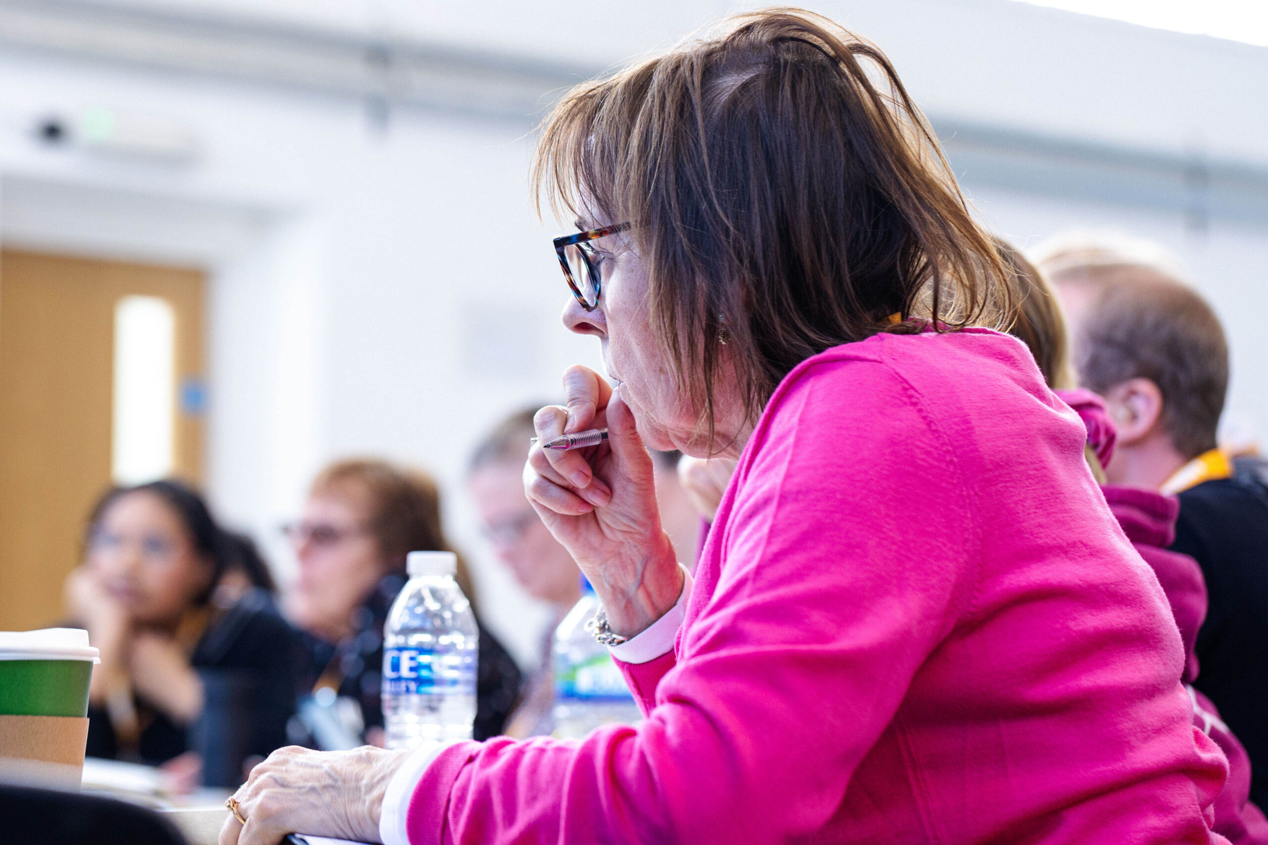 A teacher sits at a desk during a teacher training course.