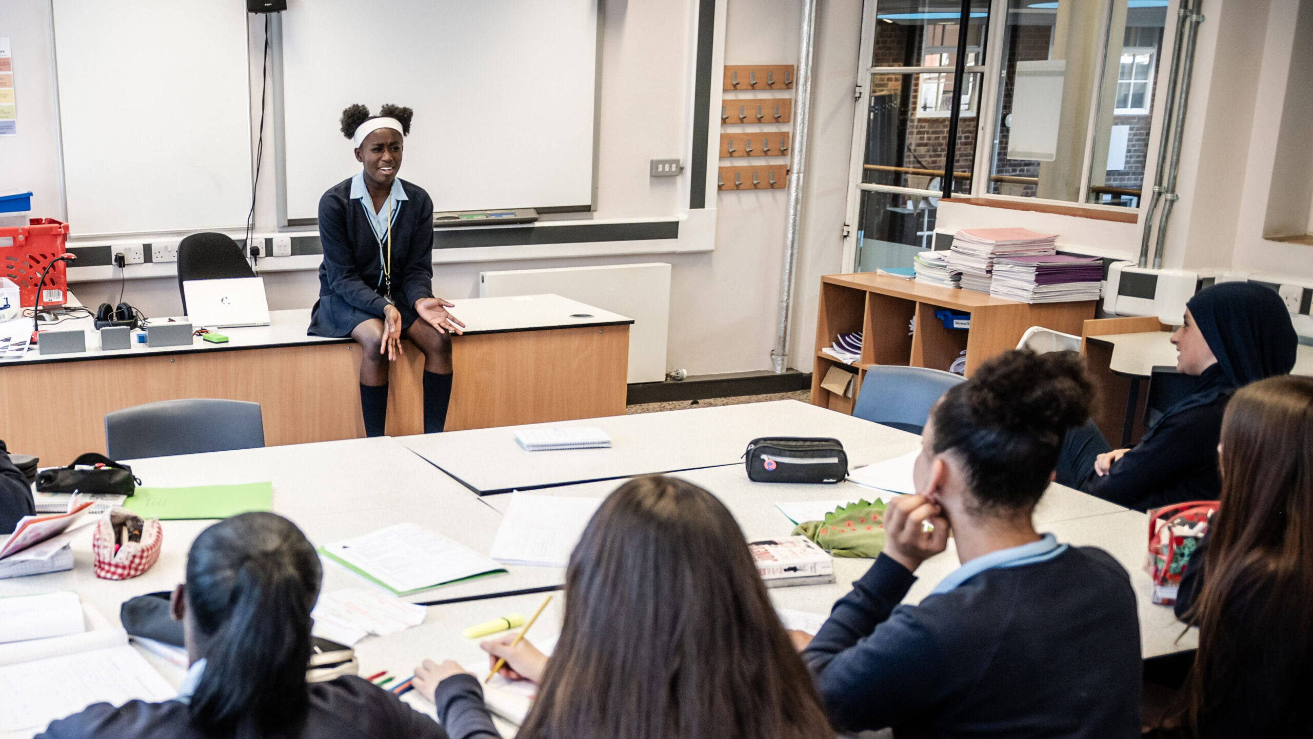 A student at the front of the class presents to the group