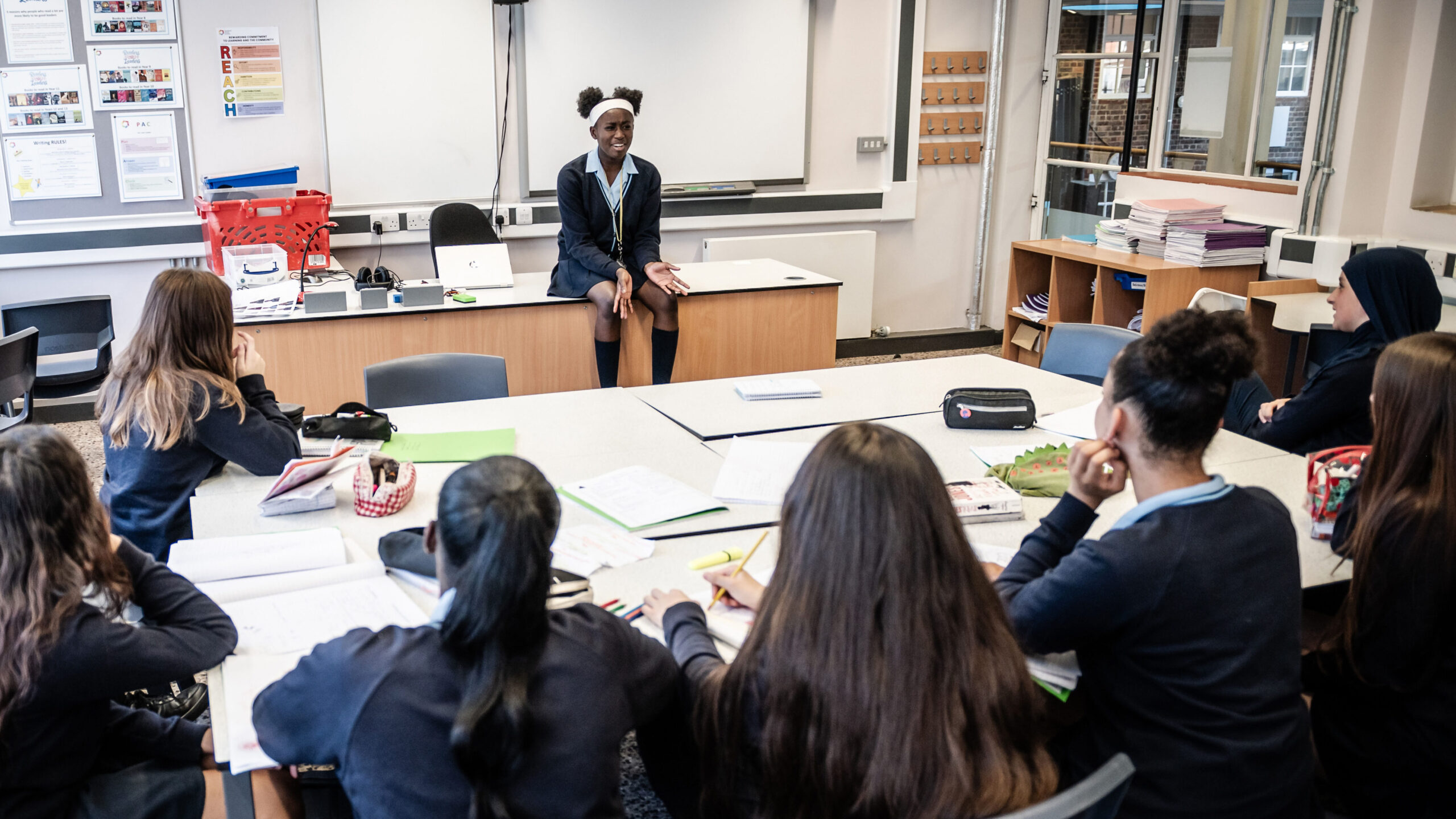 A student at the front of the class presents to the group