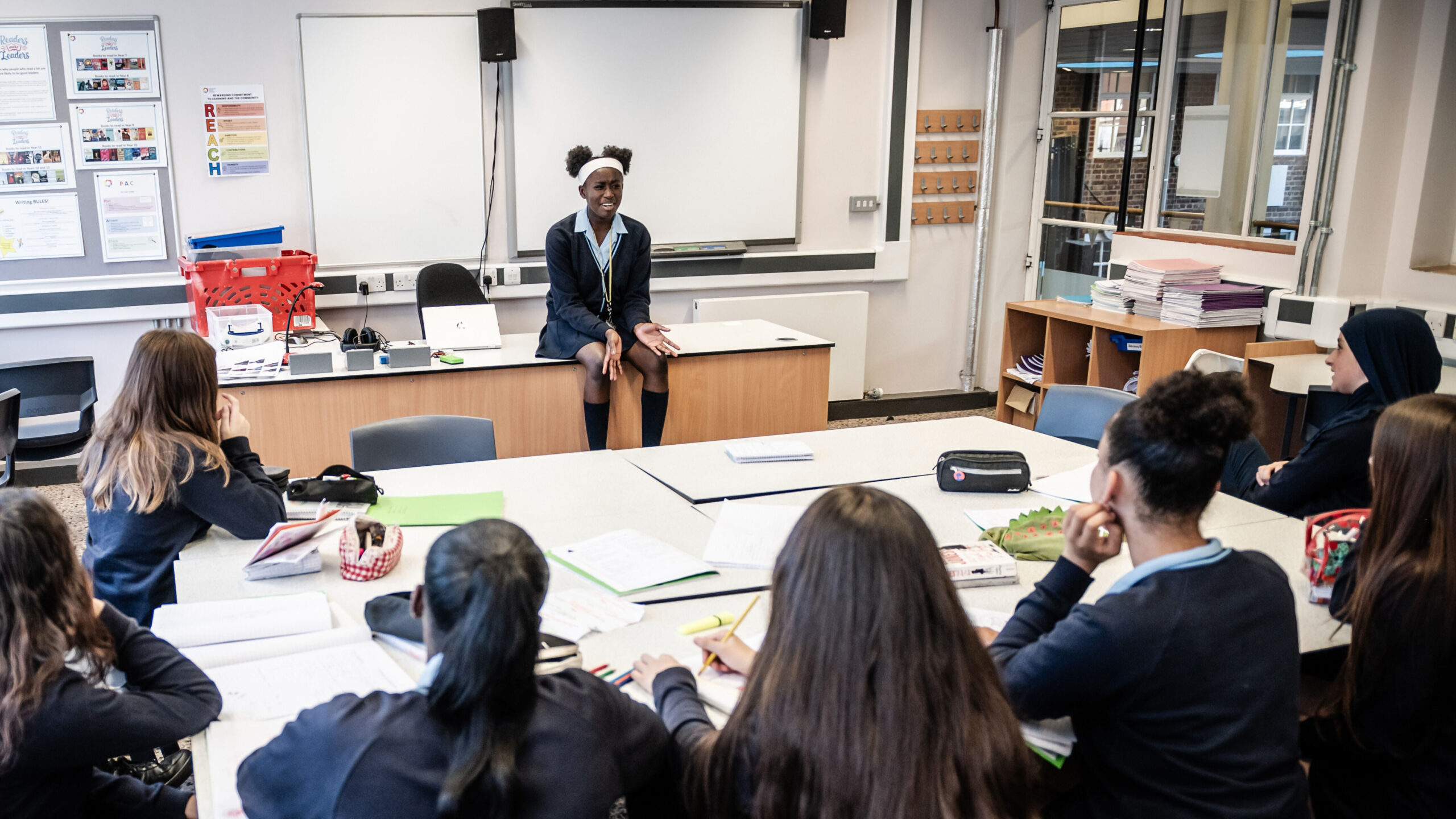A student at the front of the class presents to the group