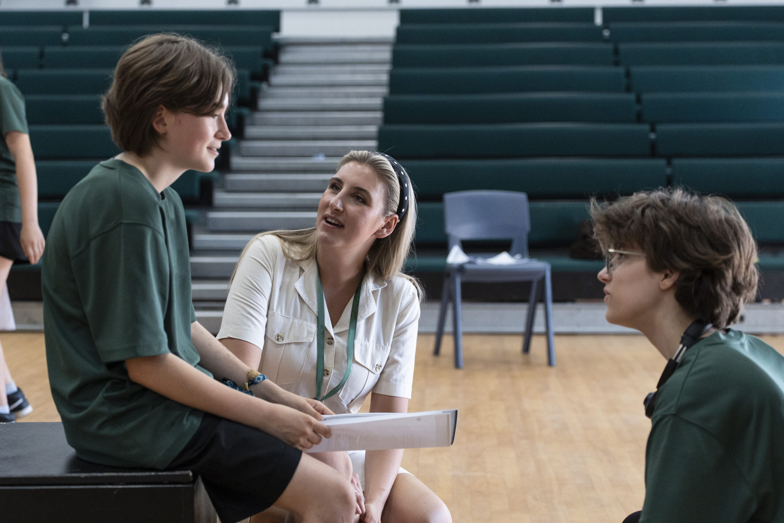 A teacher speaks to two learners