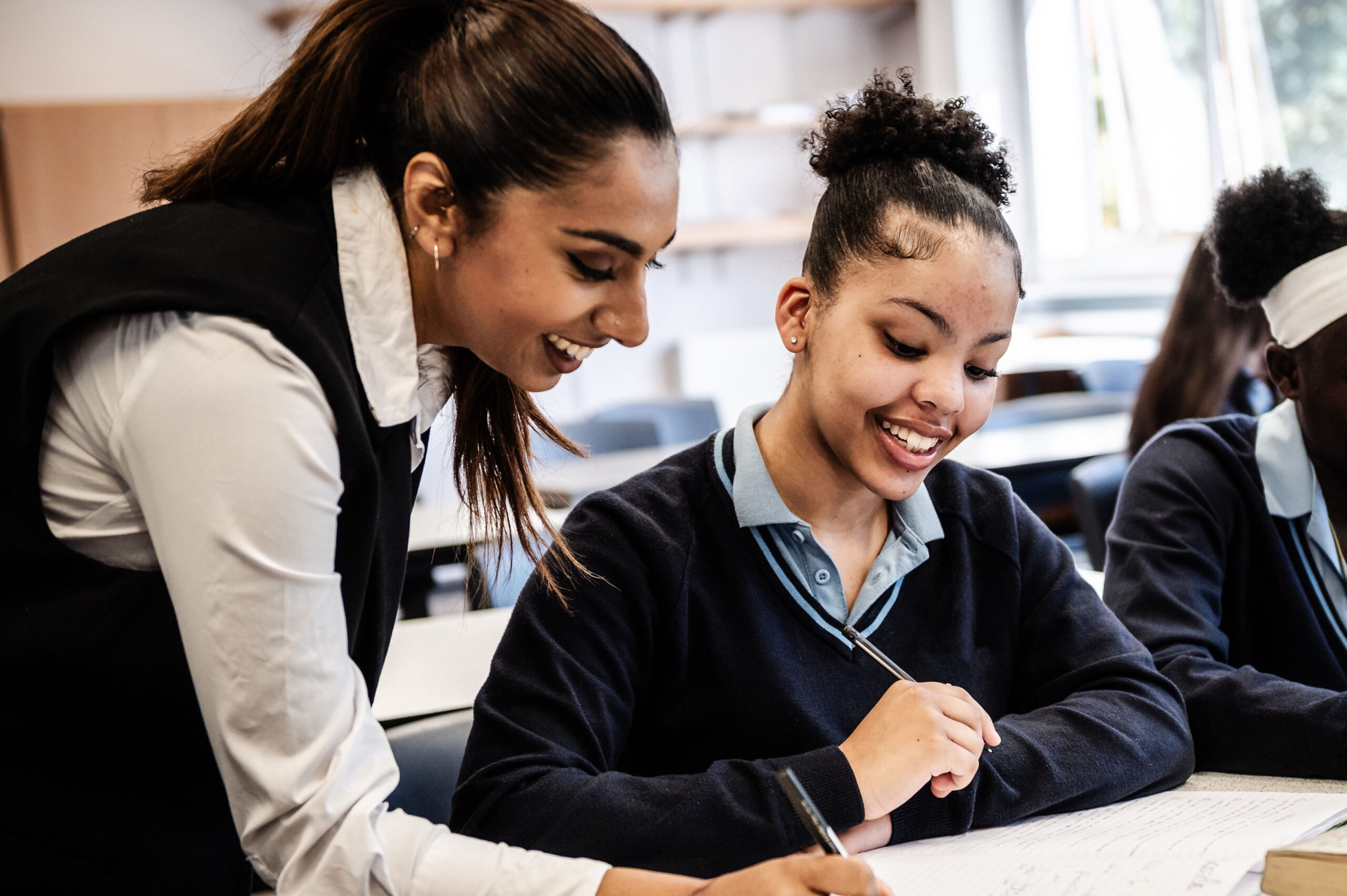 A teacher helps a learner with school work