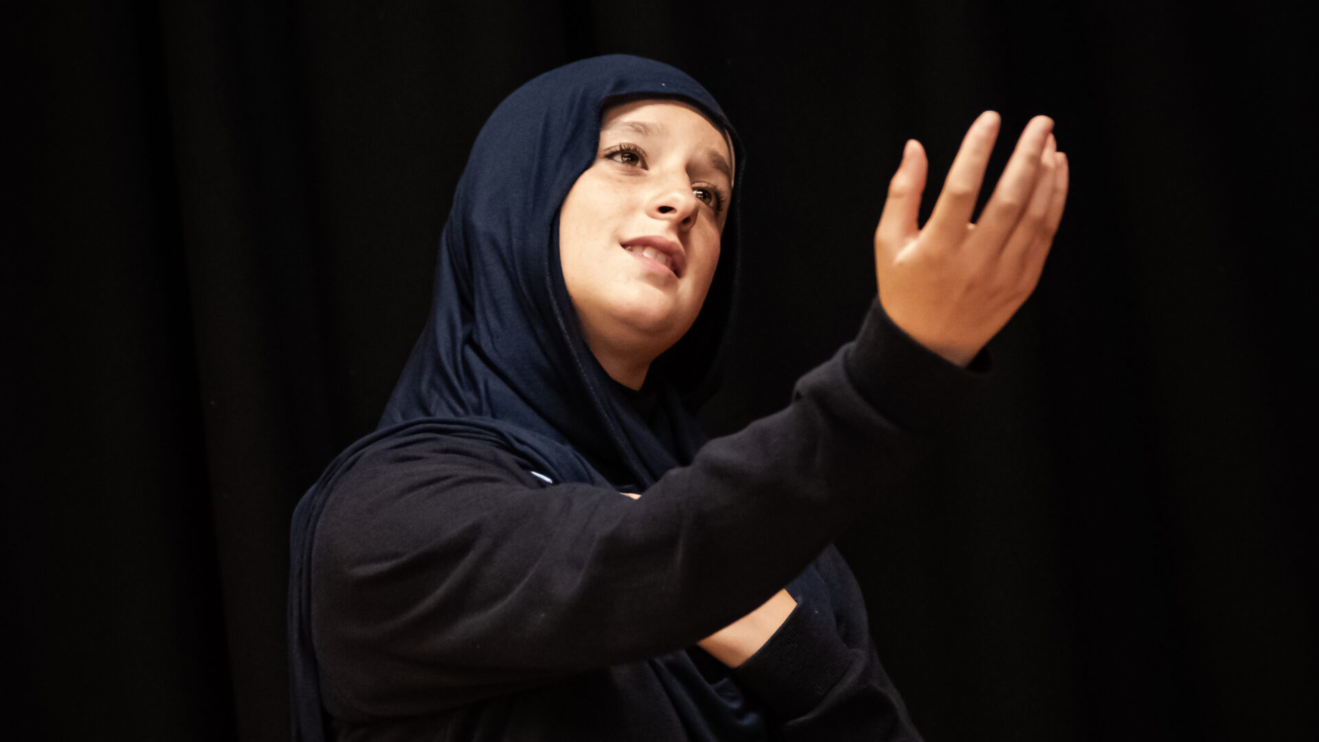A learner performs with their arm held out