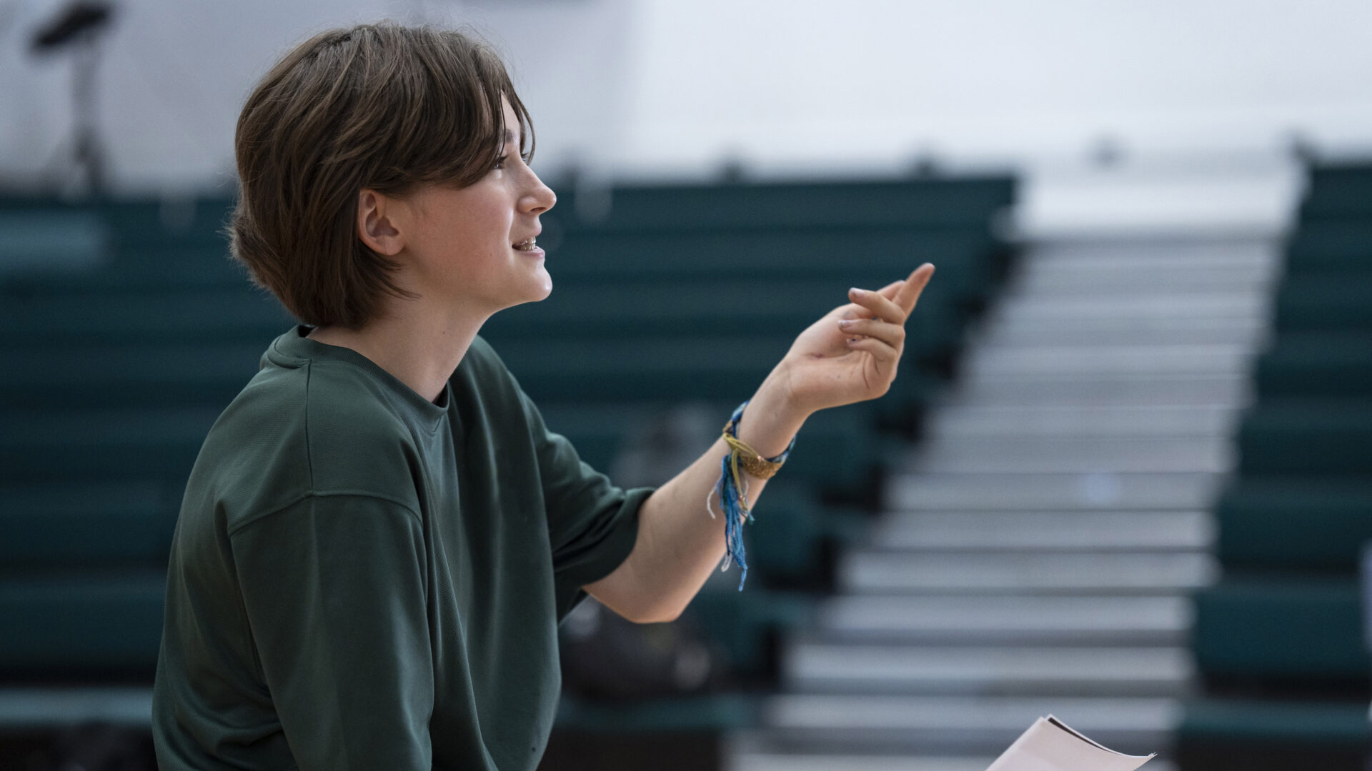 An Exams learner in class holding a piece of paper