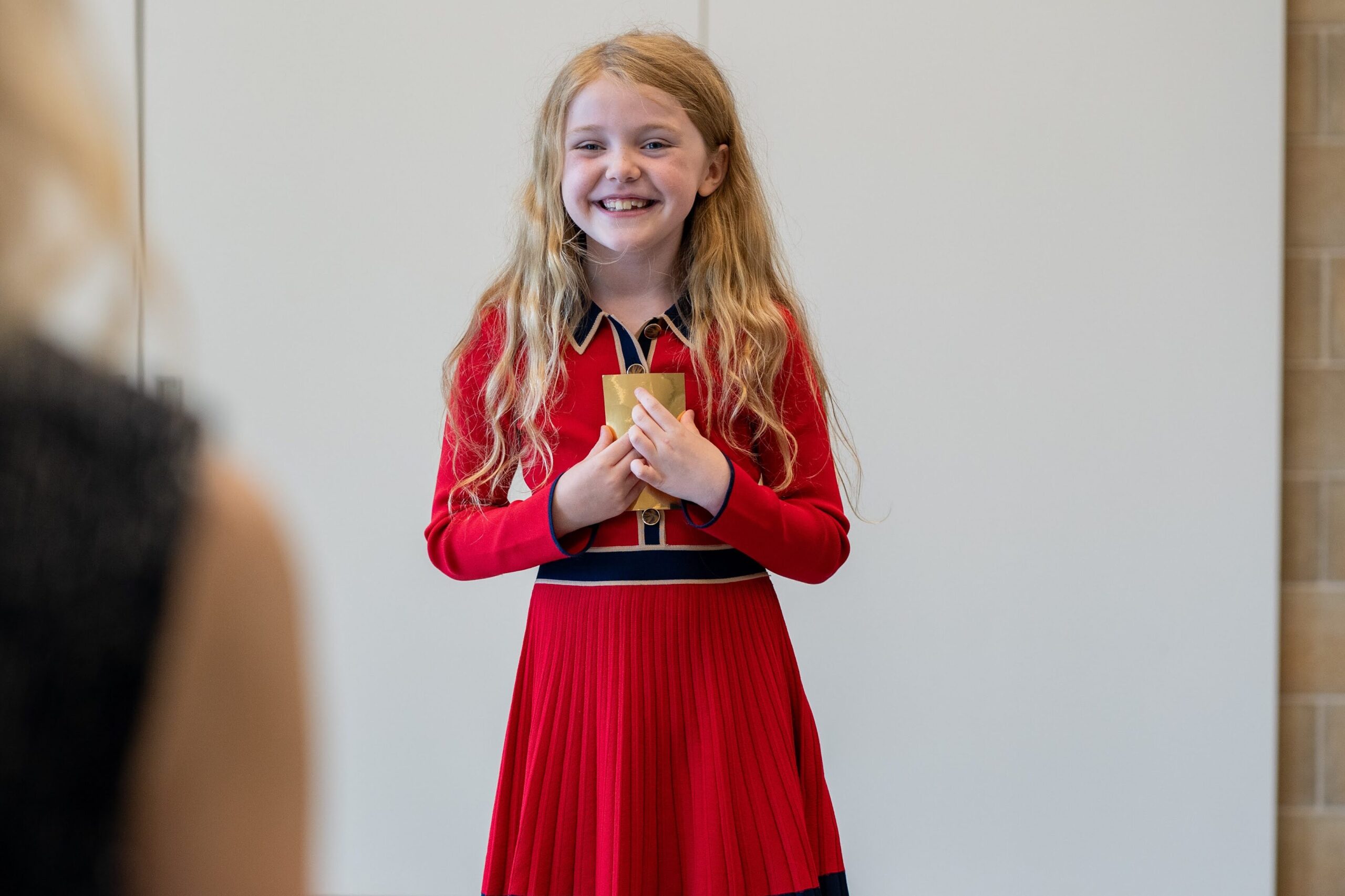 A learner holds a prop during a performance