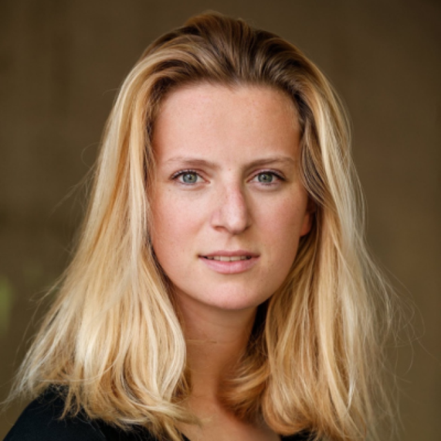 Portrait of a young woman with long blonde hair, looking directly at the camera