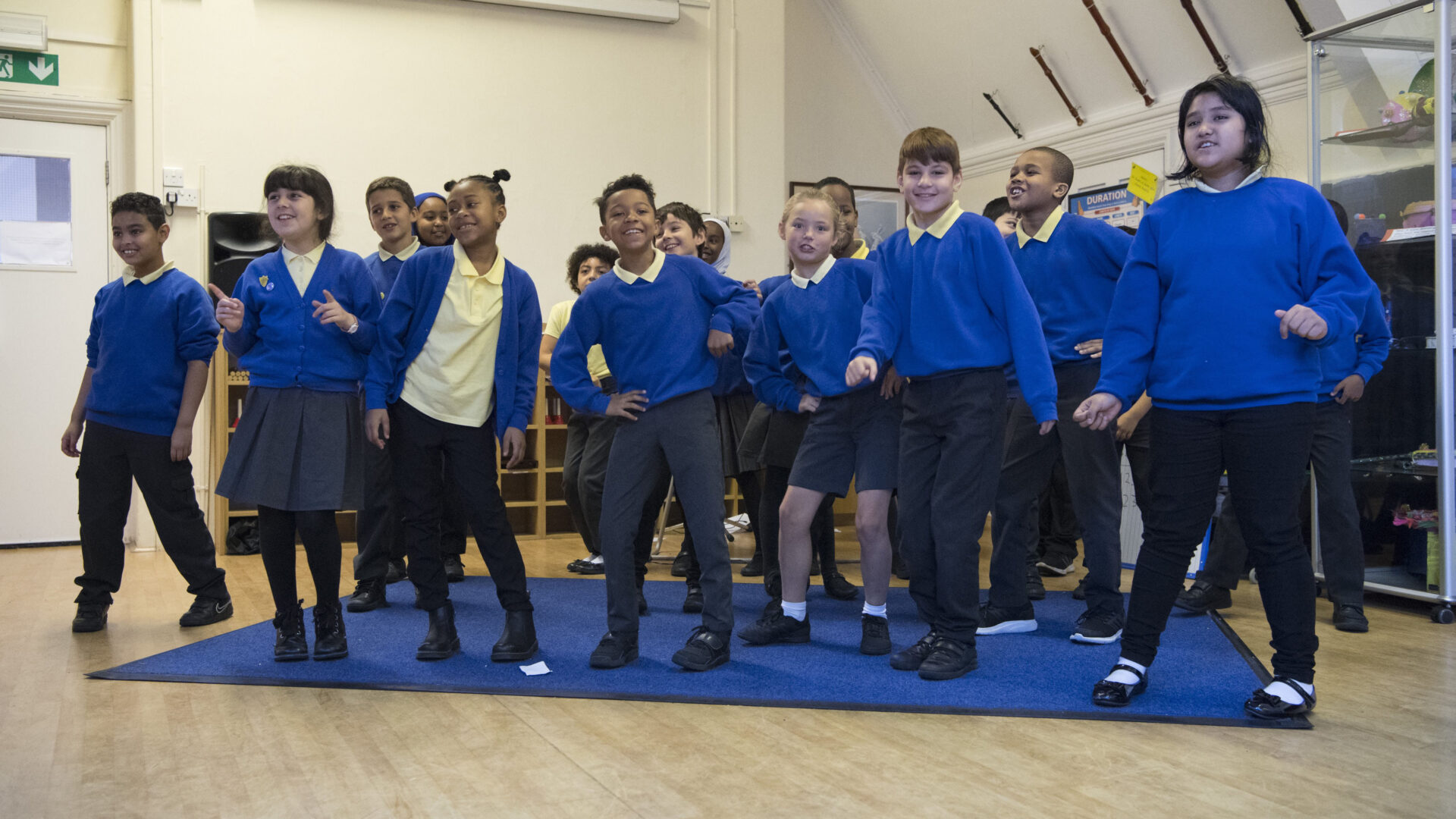 A group of learner sing in a classroom