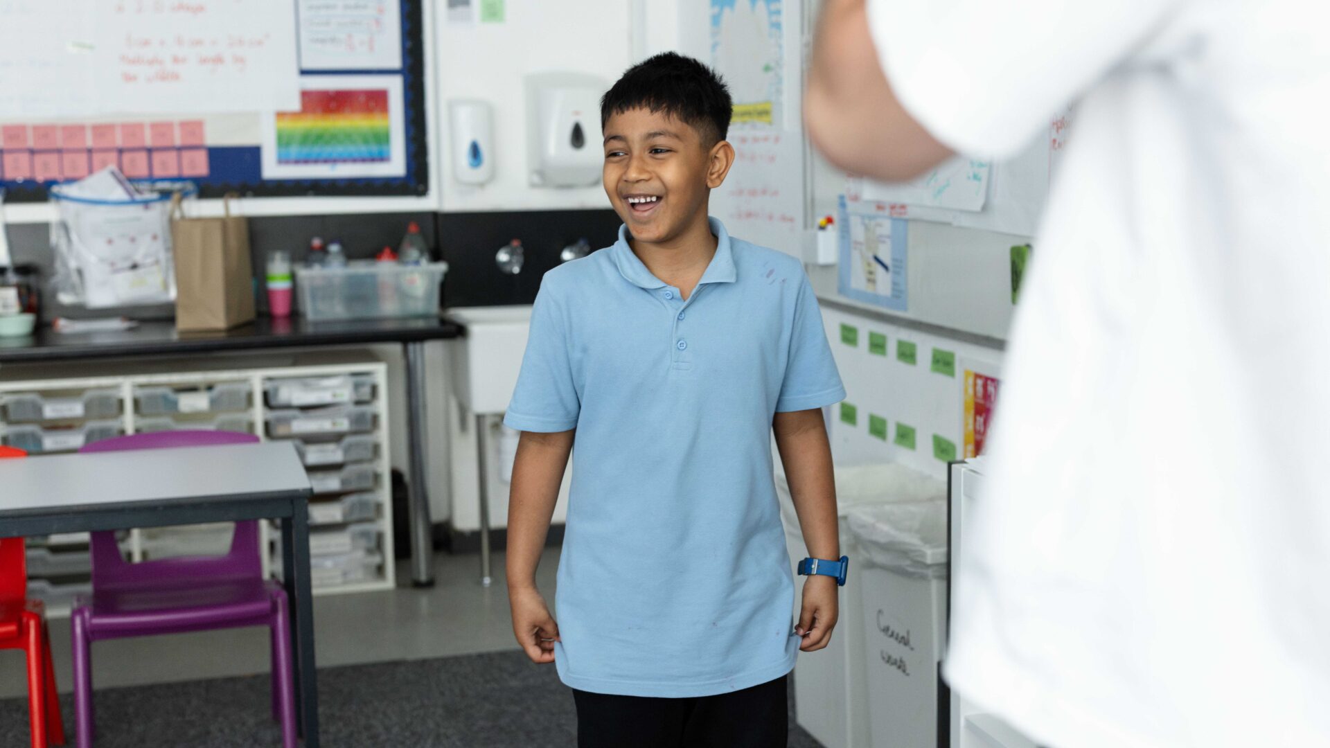 A learner stands at the front of class