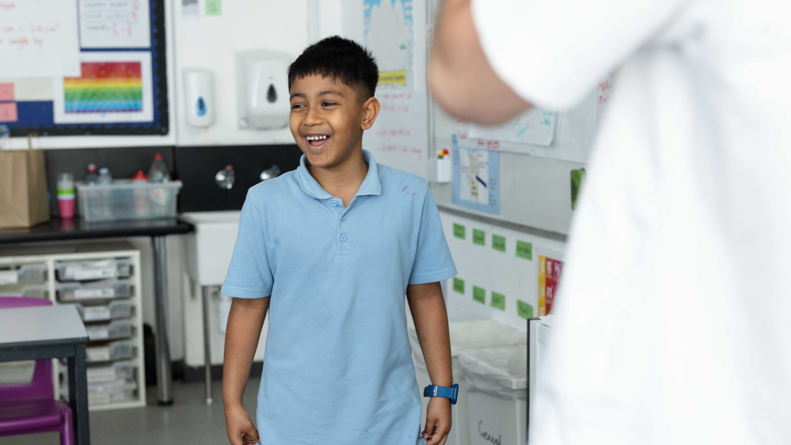A learner stands at the front of class