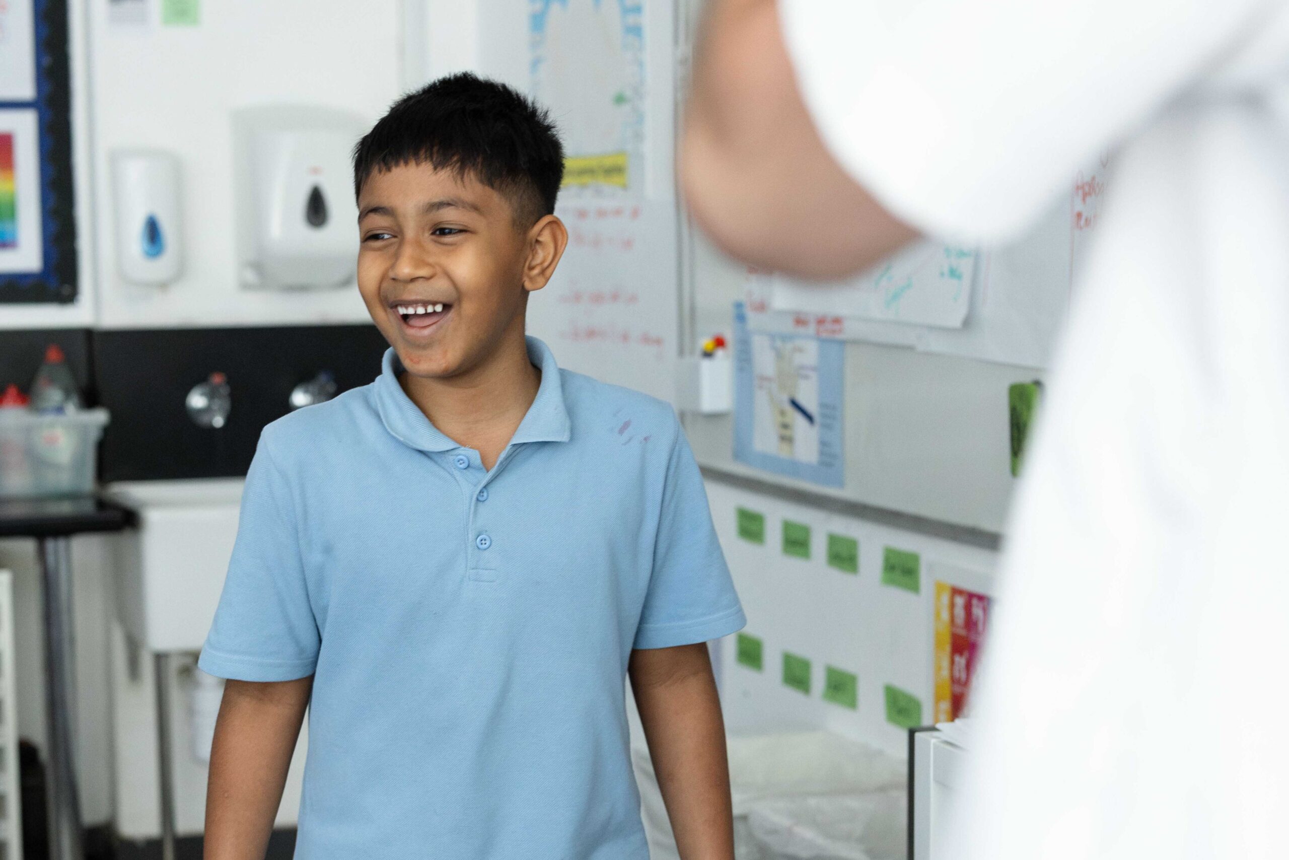 A learner stands at the front of class