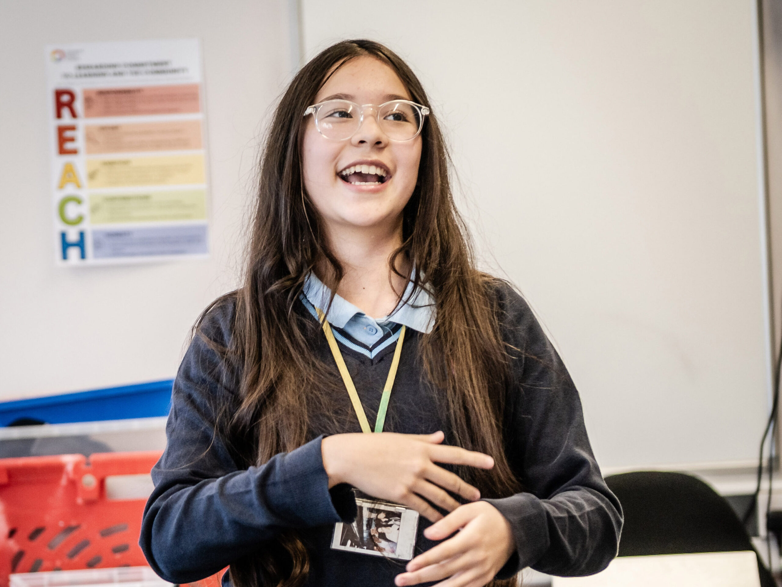 A learner presents at the front of class