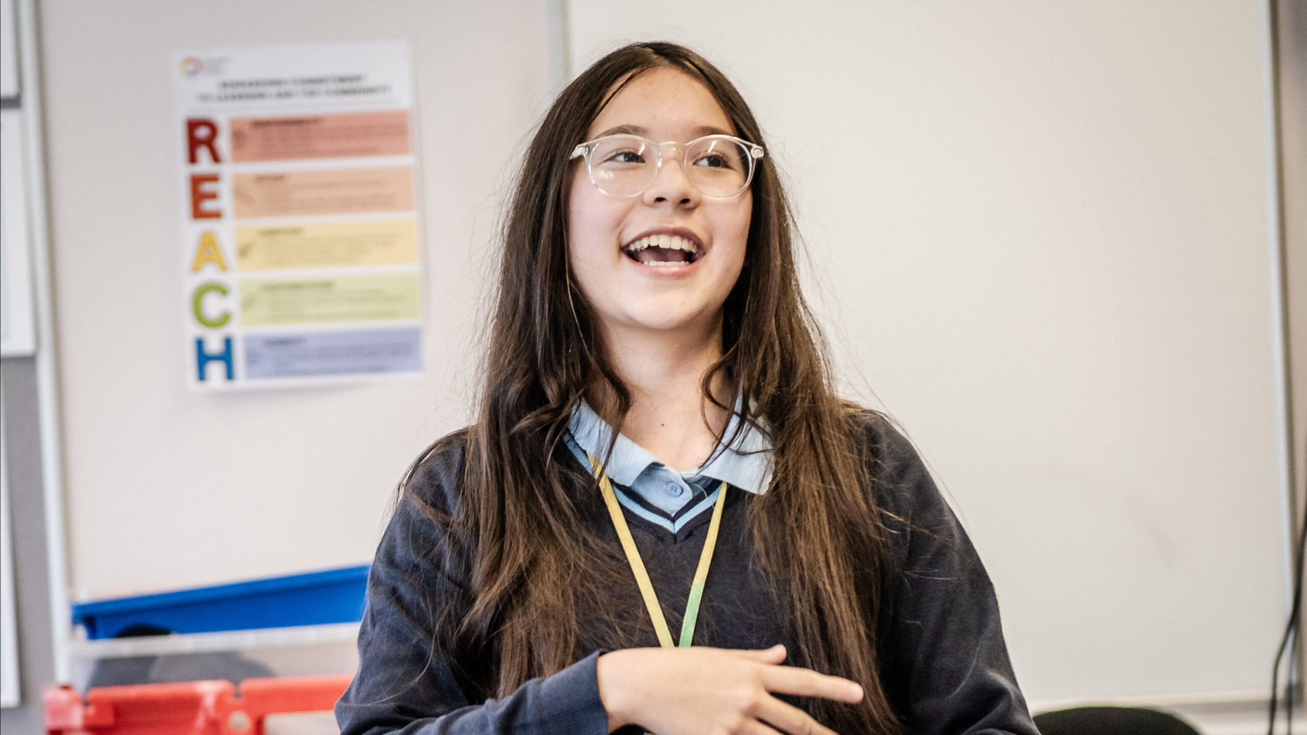 A learner presents at the front of class