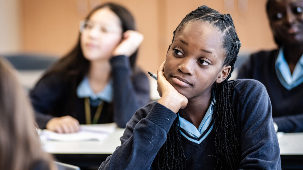 A learner listens while sitting in class